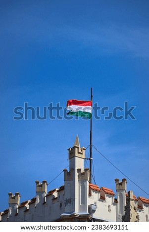 Hungarian national flag on top of a castle