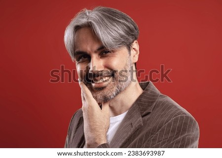 man with hand on face smiling