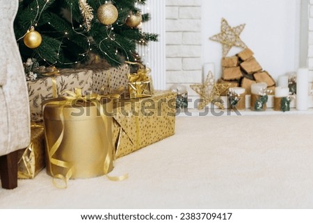 Cozy flat apartment photo studio room green Christmas Tree gifts presents garlands, candles decorated toys balls interior New Year lights glowing bokeh
