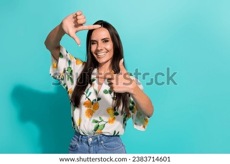 Photo of funky carefree girl pretty girl wear stylish clothes have fun make professional picture isolated on vivid cyan color background