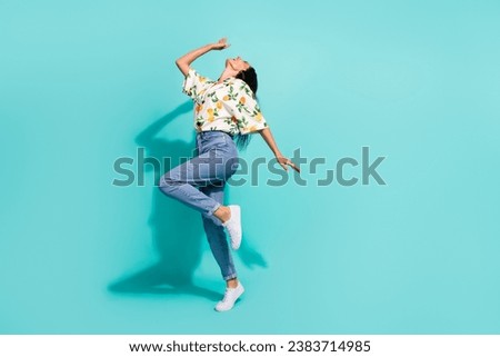 Full size photo of satisfied overjoyed woman dressed flower print blouse having fun dancing isolated on turquoise color background
