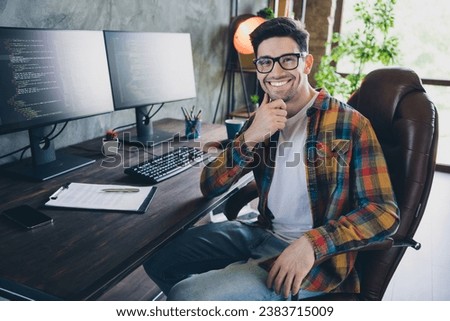 Photo young confident man think creative ideas touch chin in front of two pc monitors solving bugs program isolated indoors office