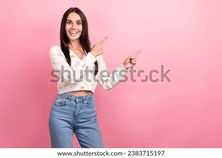 Photo of funny laughing young woman brunette hair pointing fingers empty space big promo advertisement isolated on pink color background