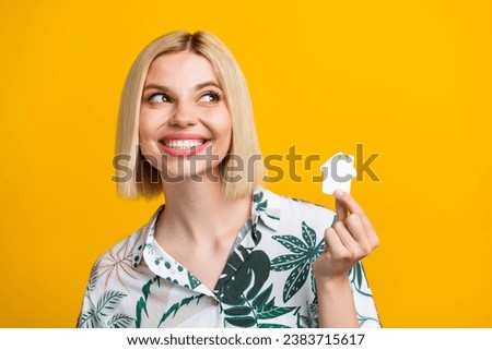 Photo portrait of attractive young woman look empty space house dressed stylish leaves print clothes isolated on yellow color background