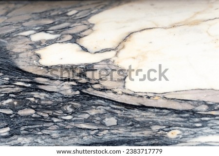 Mulitcolored marble slab close up black gray beige cream colored decorative abstract design element background