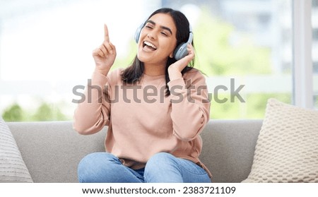 Singing and listening to music or audio with headphones musician and vocal student streaming songs at home. Young, creative and happy woman can sing song after practicing from melody and sound Royalty-Free Stock Photo #2383721109