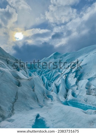 A view of the ice mountain and the sun at the top. Perito Moreno Glacier in Argentine Patagonia Royalty-Free Stock Photo #2383731675