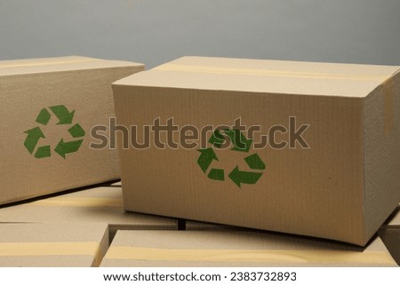 Cardboard boxes with recycle sign stamps on grey background Royalty-Free Stock Photo #2383732893