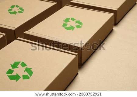 Cardboard boxes with recycle sign stamps on paper Royalty-Free Stock Photo #2383732921