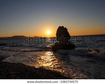 Sunset in a rocky beach of Rhodes Greece 