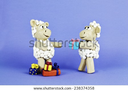 Clay sheep is presenting a gift