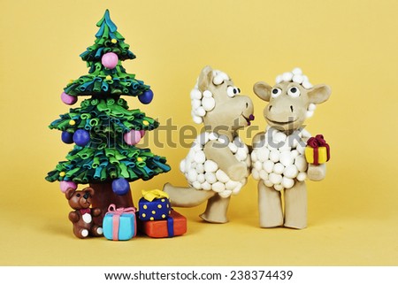 Kissing sheep near Christmas tree