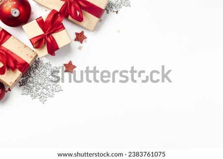 Bright Christmas background with christmas decorations, balls, gift boxes with red ribbon, tie bow on white background with copy space top view. Winter holidays, New Year concept