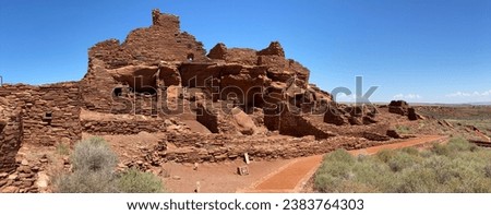 Wupatki National Monument in Arizona. Wupatki Pueblo, a multi-room pueblo built on natural rock outcrop by Ancient Pueblo People, (Cohonina, Kayenta, and Sinagua) from local red Moenkopi sandstone. Royalty-Free Stock Photo #2383764303