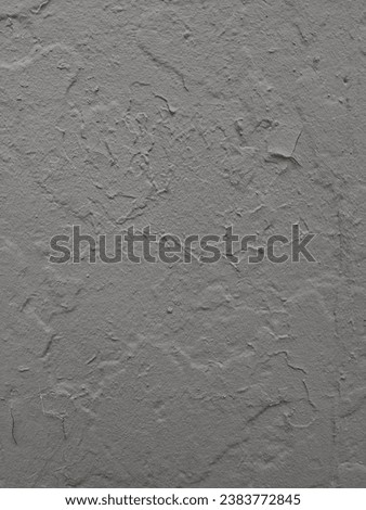Close-up of a gray wall with unique textures and patterns, perfect for adding grain effects in photo editing