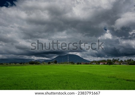 Storm clouds gather over a hill, creating a very dramatic landscape Bukit Mertajam city, Pulau Pinang Malaysia during the Southwest Monsoon. Royalty-Free Stock Photo #2383791667