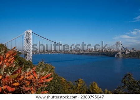 A distance view of George Washington Bridge in the Fort Lee Historic park in Autumn Royalty-Free Stock Photo #2383795047