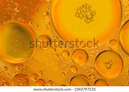 Golden drops of oil or serum texture background. Oil drops on the water's surface. Macro photography
 Royalty-Free Stock Photo #2383797535