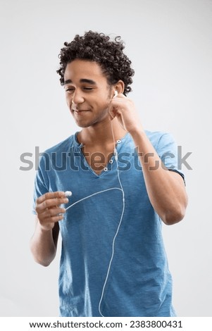 Young man with a pleasant smile about to enjoy his music