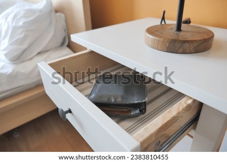 a wallet in a open drawer closeup. Royalty-Free Stock Photo #2383810455