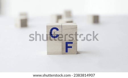 Wooden Blocks with the blue text: CF. Cash flow (CF), the revenue or expense expected to be generated through business activities (sales, manufacturing) over a period of time. Wood block with text.