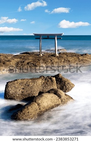 stunning photo of a torii gate floating in the ocean at Oarai Isosaki Shrine in Japan. This iconic image is a symbol of Japanese culture and spirituality.