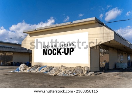 blank billboard on the wall of a warehouse. It's the perfect mockup for outdoor advertising, and it's easy to customize with your own designs.
