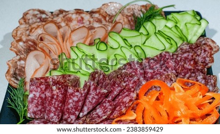 A plate of Sliced Processed Salami meats decorated with vegetables