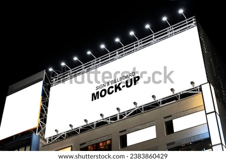 blank billboard on the roof of a city building at night. Perfect for showcasing your advertising campaign or mockup design.