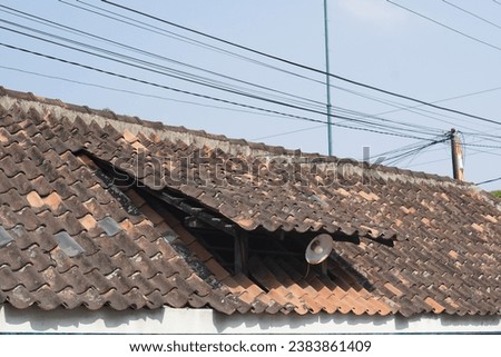 old red tiles roof and blue sky, Traditional tile roof in Indonesia