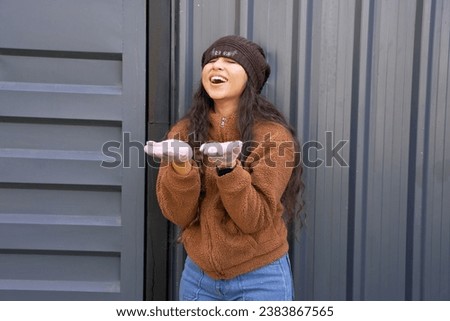 Beautiful young indian woman eyes closed enjoying vacation and feeling happy with snow fall