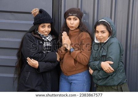 Group of three Young indian women freezing , shivering, Wearing warm winter clothes Royalty-Free Stock Photo #2383867577