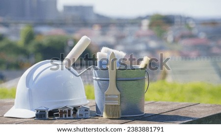 Painting tools, model house and hard hat. Image of painting industry, renovation and DIY. Royalty-Free Stock Photo #2383881791