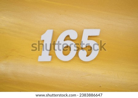 The golden yellow painted wood panel for the background, number 165, is made from white painted wood.