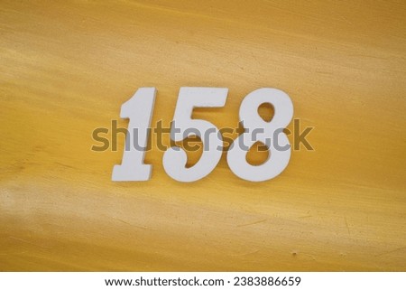 The golden yellow painted wood panel for the background, number 158, is made from white painted wood.