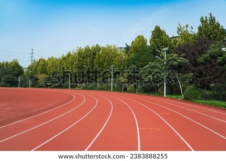 Athlete track or running track with green trees in the playground Royalty-Free Stock Photo #2383888255