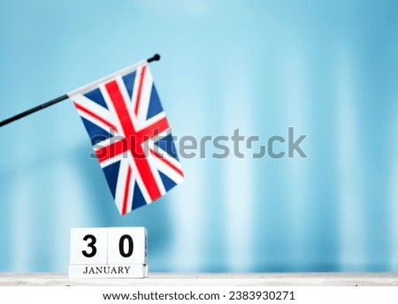 January calendar with British flag with number  30.  Calendar cubes with numbers. Space copy.