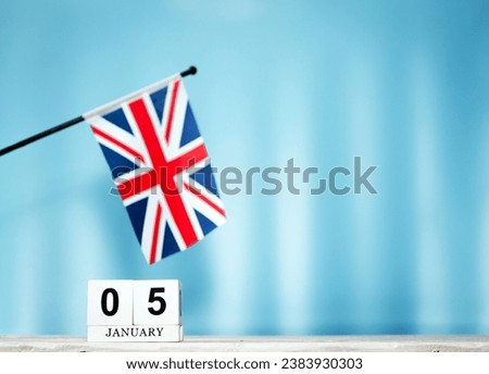 January calendar with British flag with number  5.  Calendar cubes with numbers. Space copy.