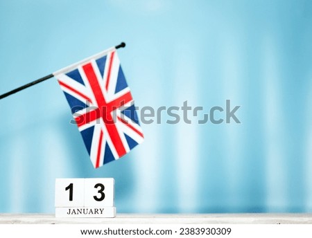 January calendar with British flag with number  13.  Calendar cubes with numbers. Space copy.