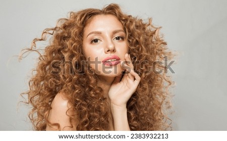 Elegant stylish beautiful young female model with curly long brown hairstyle on white background. Woman with wavy hair