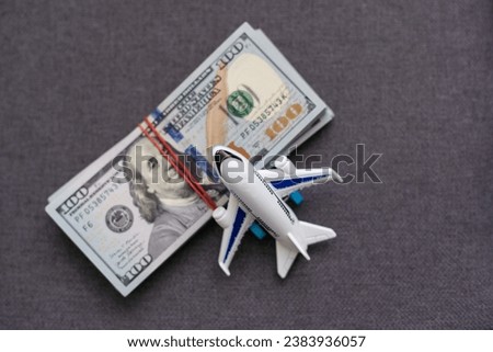 Flatlay picture of toy airplane, fake money