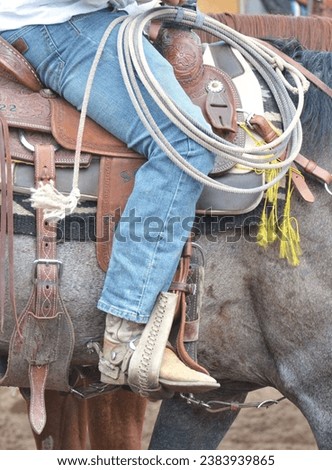 Cowboy boots, saddles, lassos, stirrups and cowboy tack. 