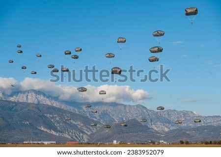 U.S. Army paratroopers assigned to the 173rd Airborne Brigade, Italian and British paratroopers conduct a multi-national proficiency airborne operation onto Juliet Drop Zone in Pordenone, Italy Royalty-Free Stock Photo #2383952079