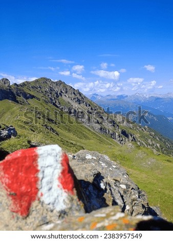 Beautiful mountain picture with a red and white painted stone in the foreground