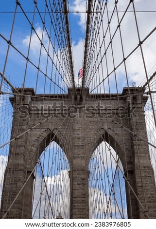 A stunning stock photo of the iconic Brooklyn Bridge, one of New York City's most popular tourist destinations. The photo captures the bridge's graceful suspension towers and its breathtaking views of