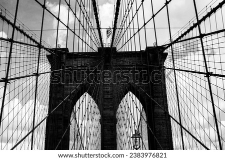 A stunning stock photo of the iconic Brooklyn Bridge, one of New York City's most popular tourist destinations. The photo captures the bridge's graceful suspension towers and its breathtaking views of