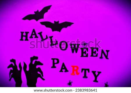 black hands and bats on the purple halloween party bacground 
