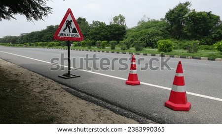 alert of danger symbol men at work  in an national highway of India