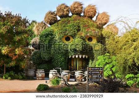 TERRA BOTANICA, ANGERS, FRANCE - SEPTEMBER 24, 2023: Head of a monster covered with ivy in a park landscape design. Grass figure Royalty-Free Stock Photo #2383990929
