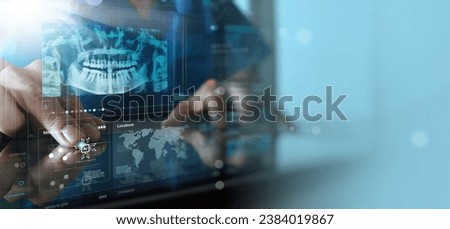 Dentist looking on the virtual Ai x-ray of a jaw working with a computer in the dental office. Royalty-Free Stock Photo #2384019867